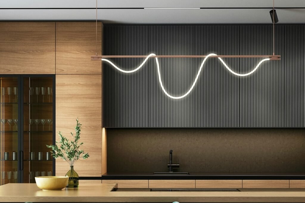 Dark modern kitchen with bar seating and sculptural lighting